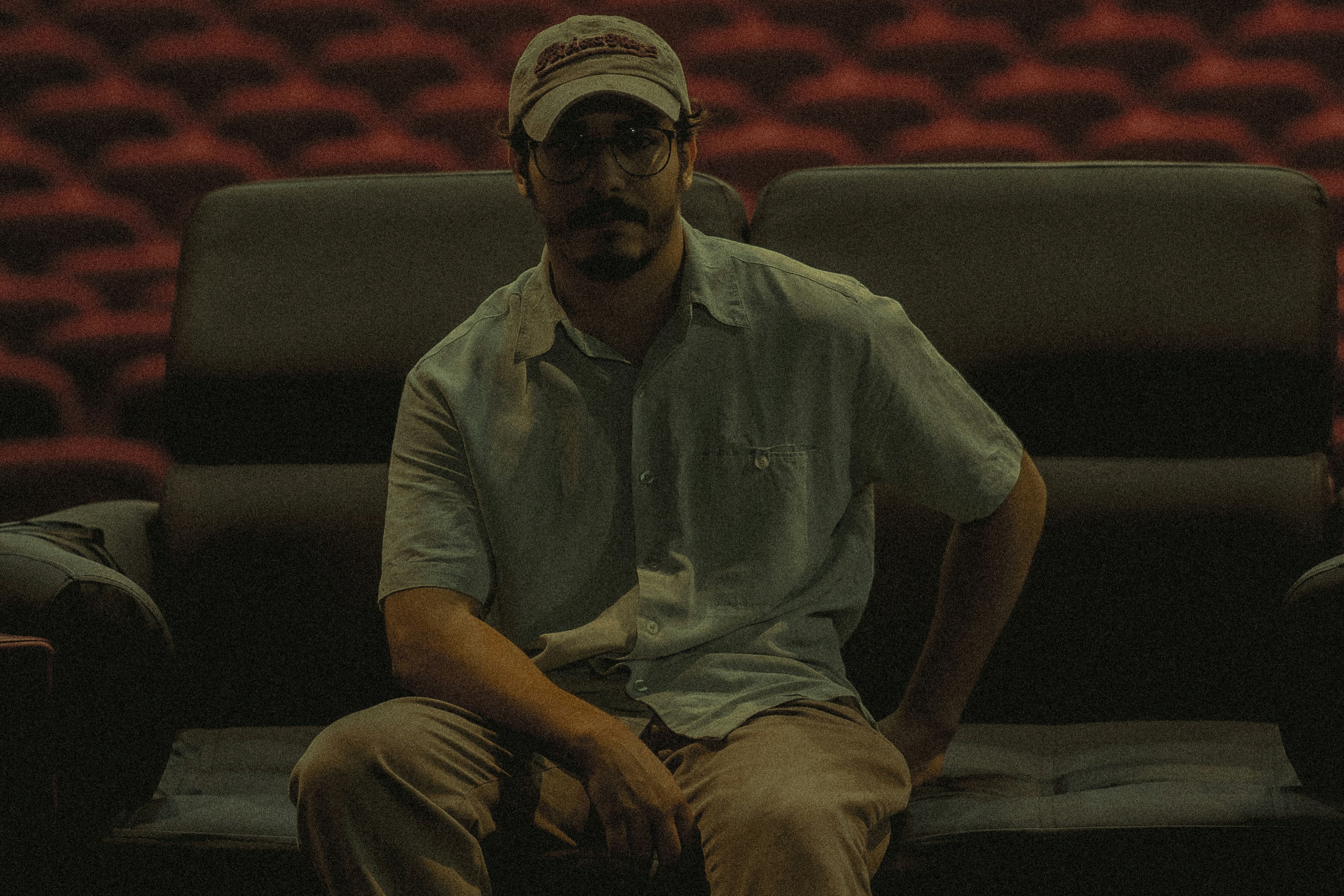 A man sitting on a couch in front of a theater