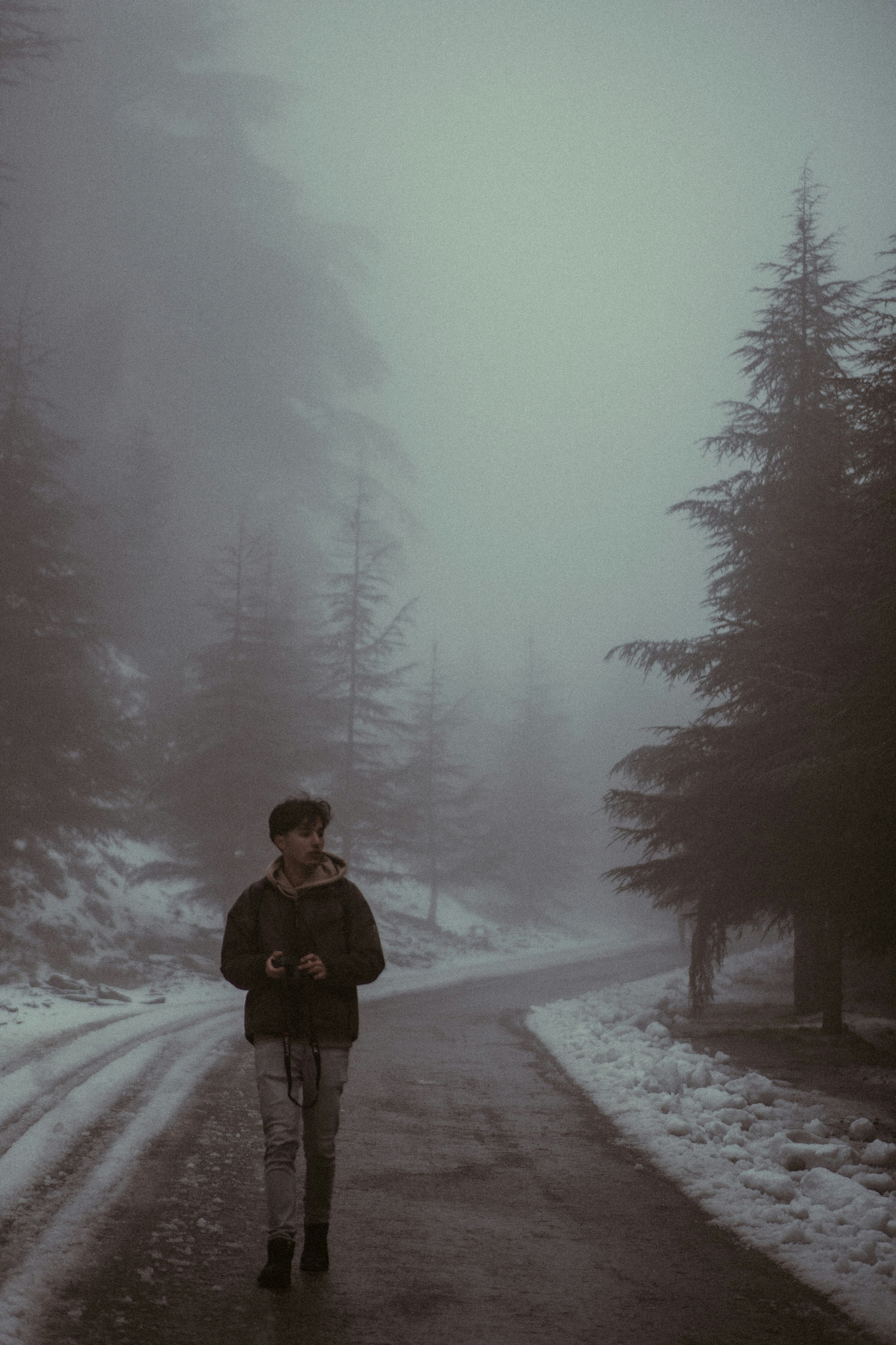 A person walking down a road in the snow
