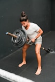 A man holding a barbell in a gym