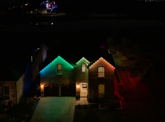 A couple of houses that are lit up at night