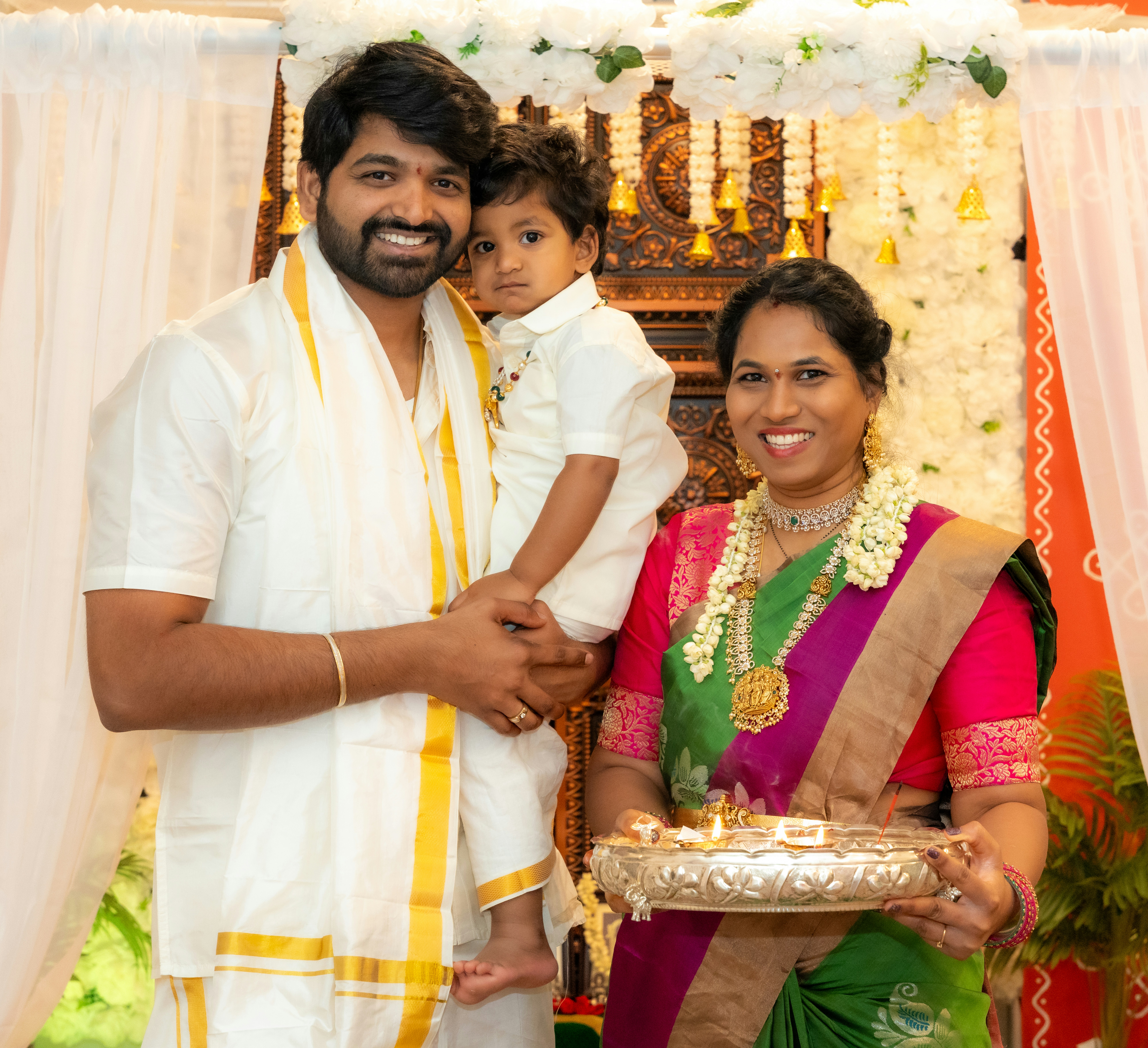 A man and woman holding a small child