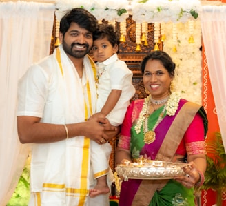 A man and woman holding a small child