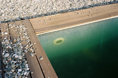 A pool surrounded by rocks and gravel