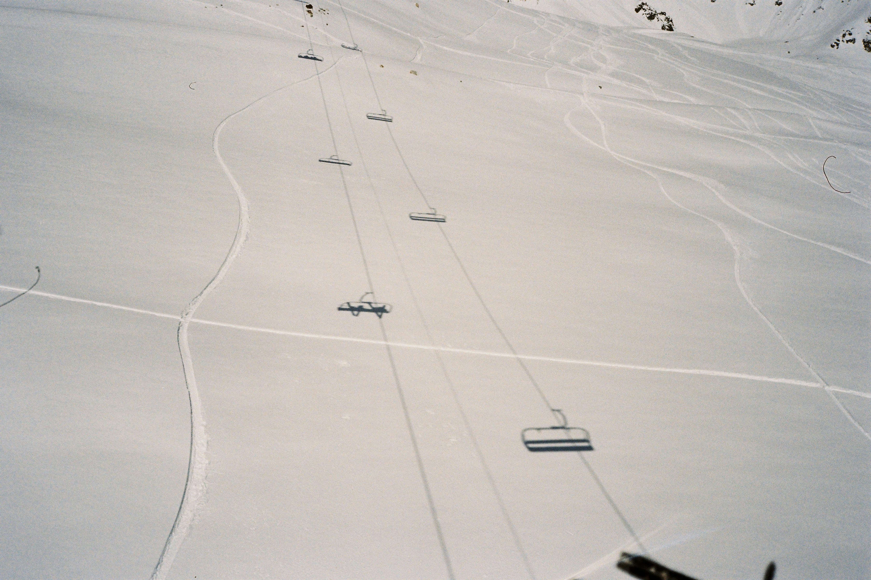 A group of people riding skis down a snow covered slope