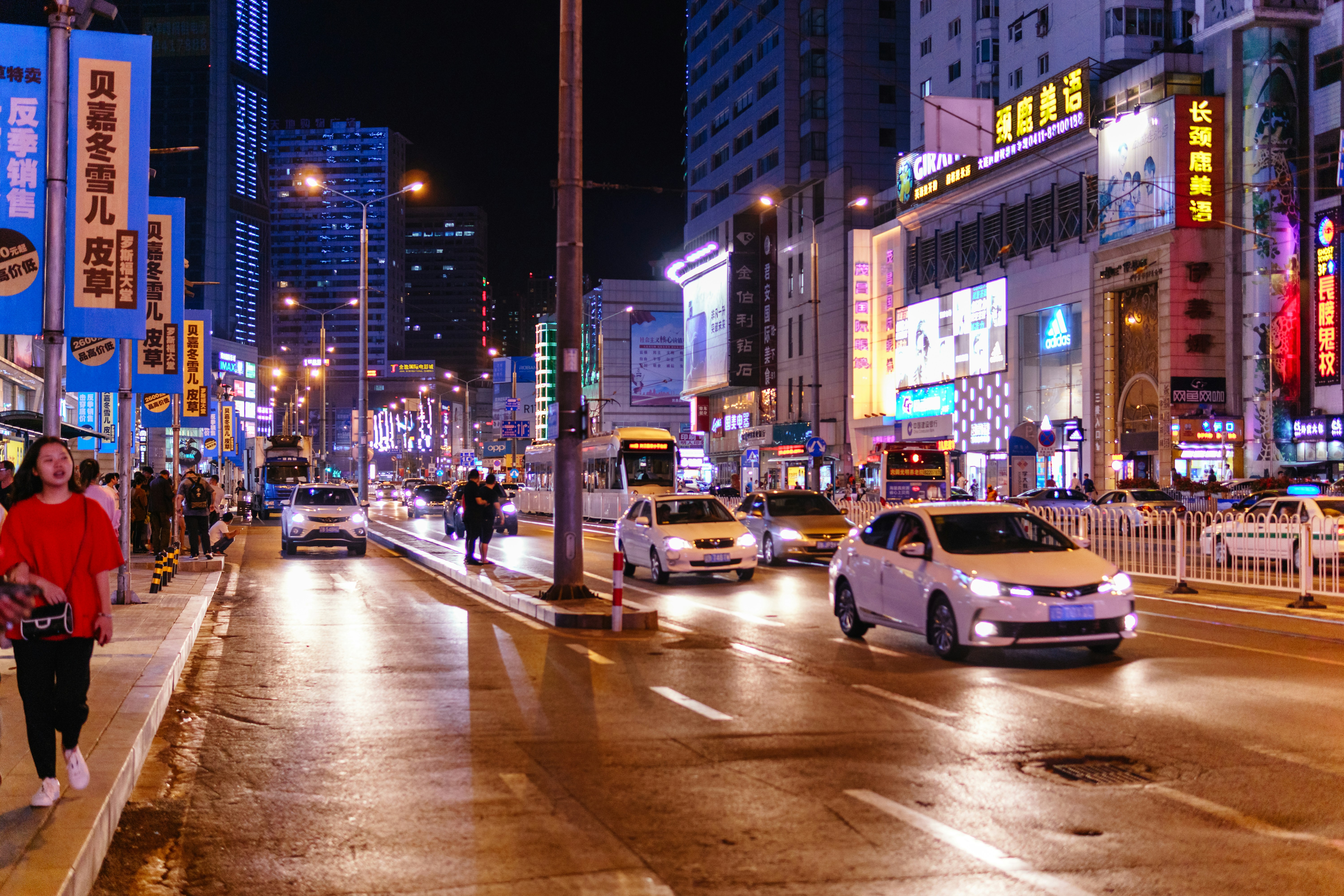 A busy city street at night with cars and people