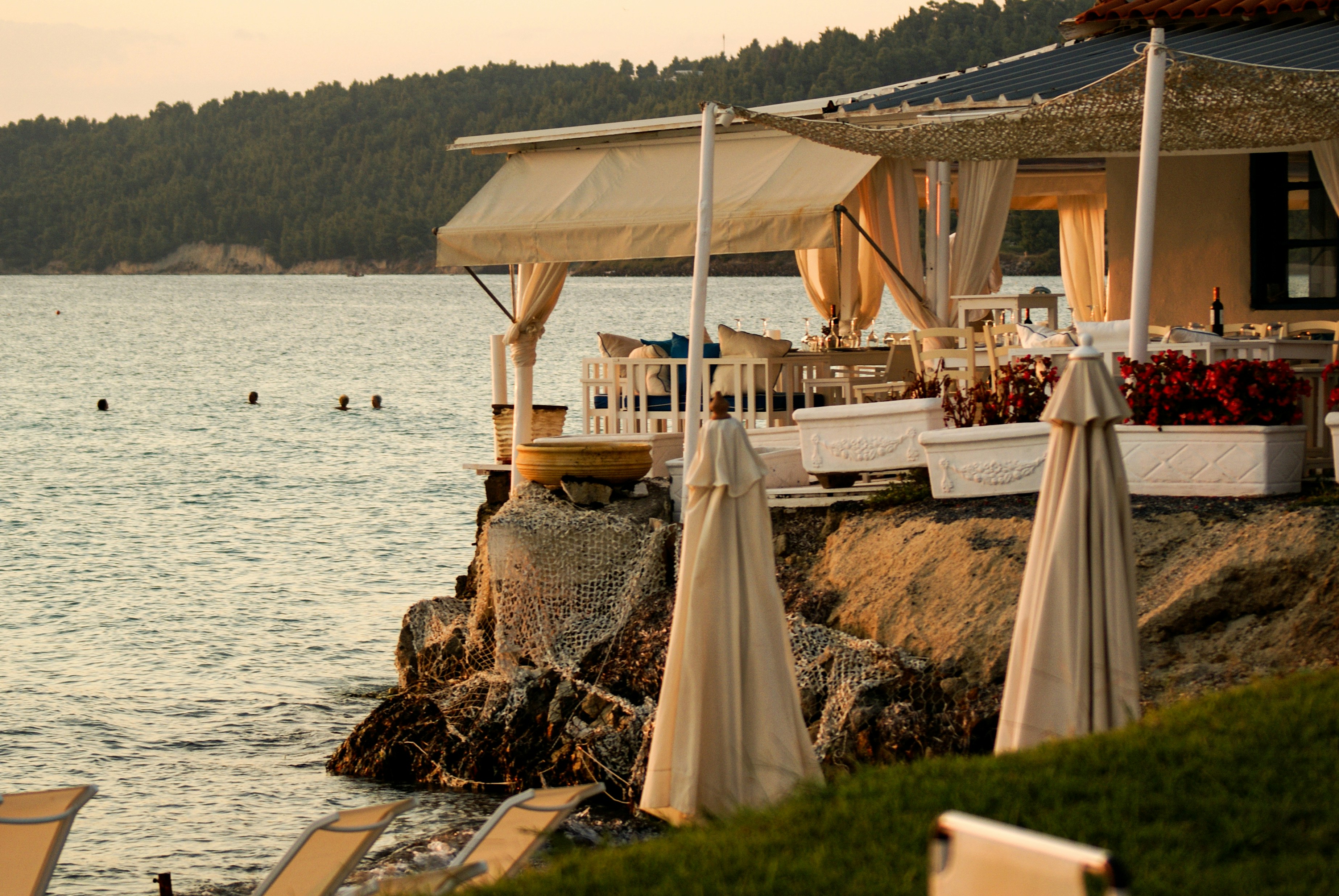 A group of chairs sitting on top of a beach next to a body of water