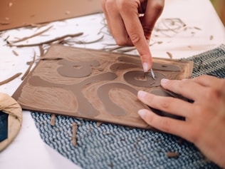 A person is working on a piece of wood
