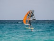 A person windsurfing in the ocean on a sunny day