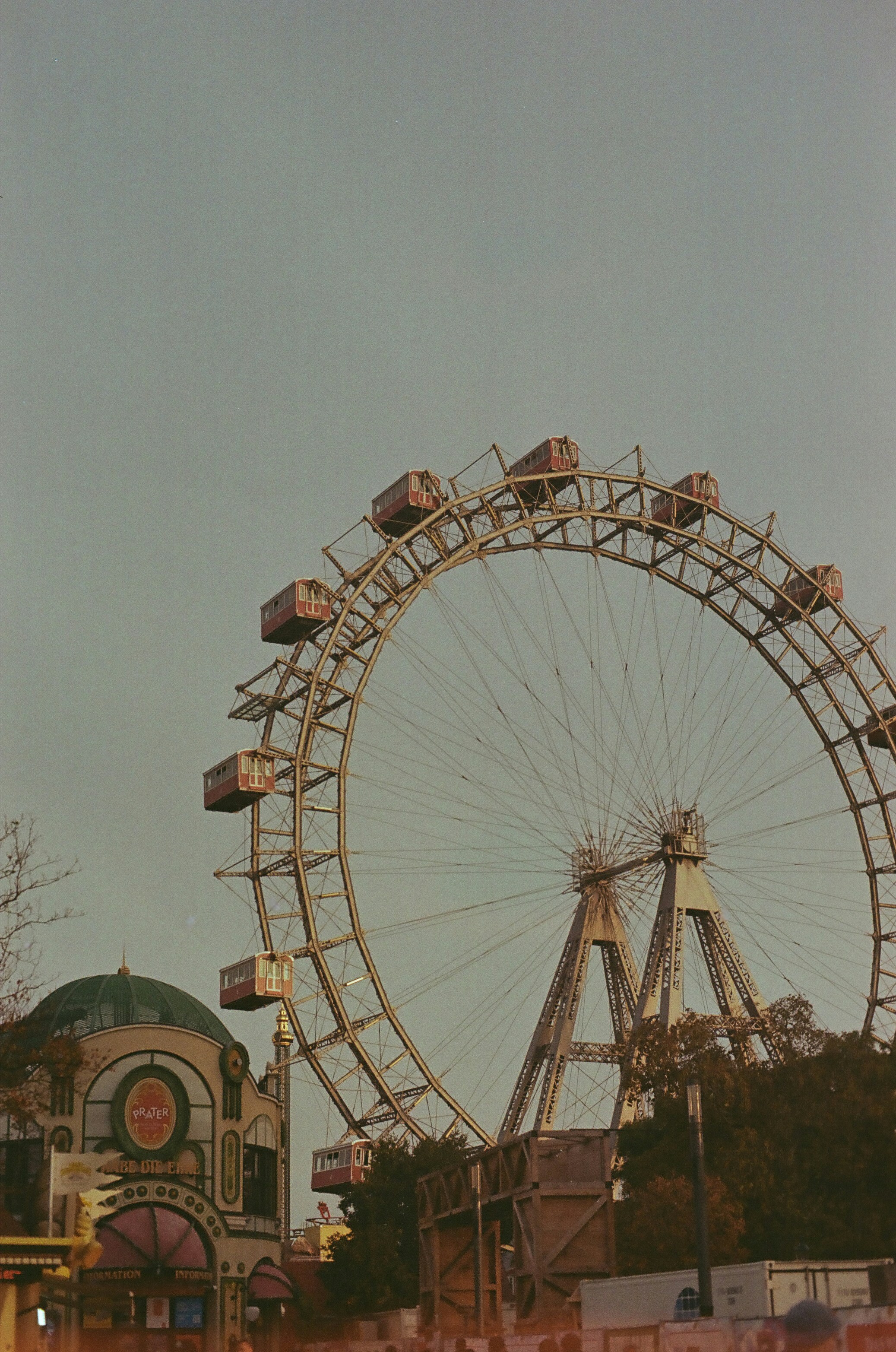 A large ferris wheel sitting next to a tall building