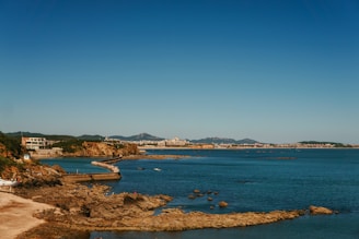 A body of water surrounded by a sandy beach
