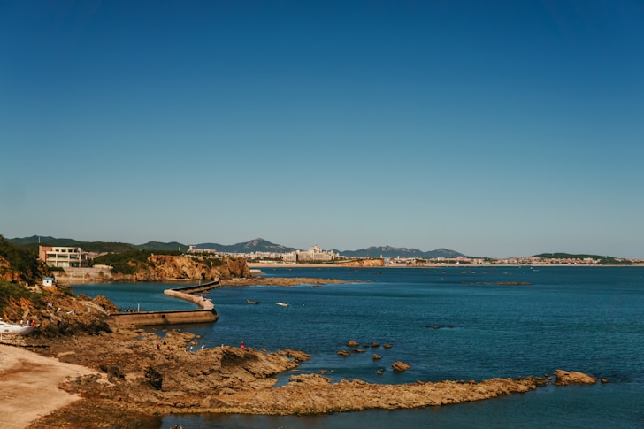 A body of water surrounded by a sandy beach