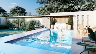 A swimming pool surrounded by a lush green yard