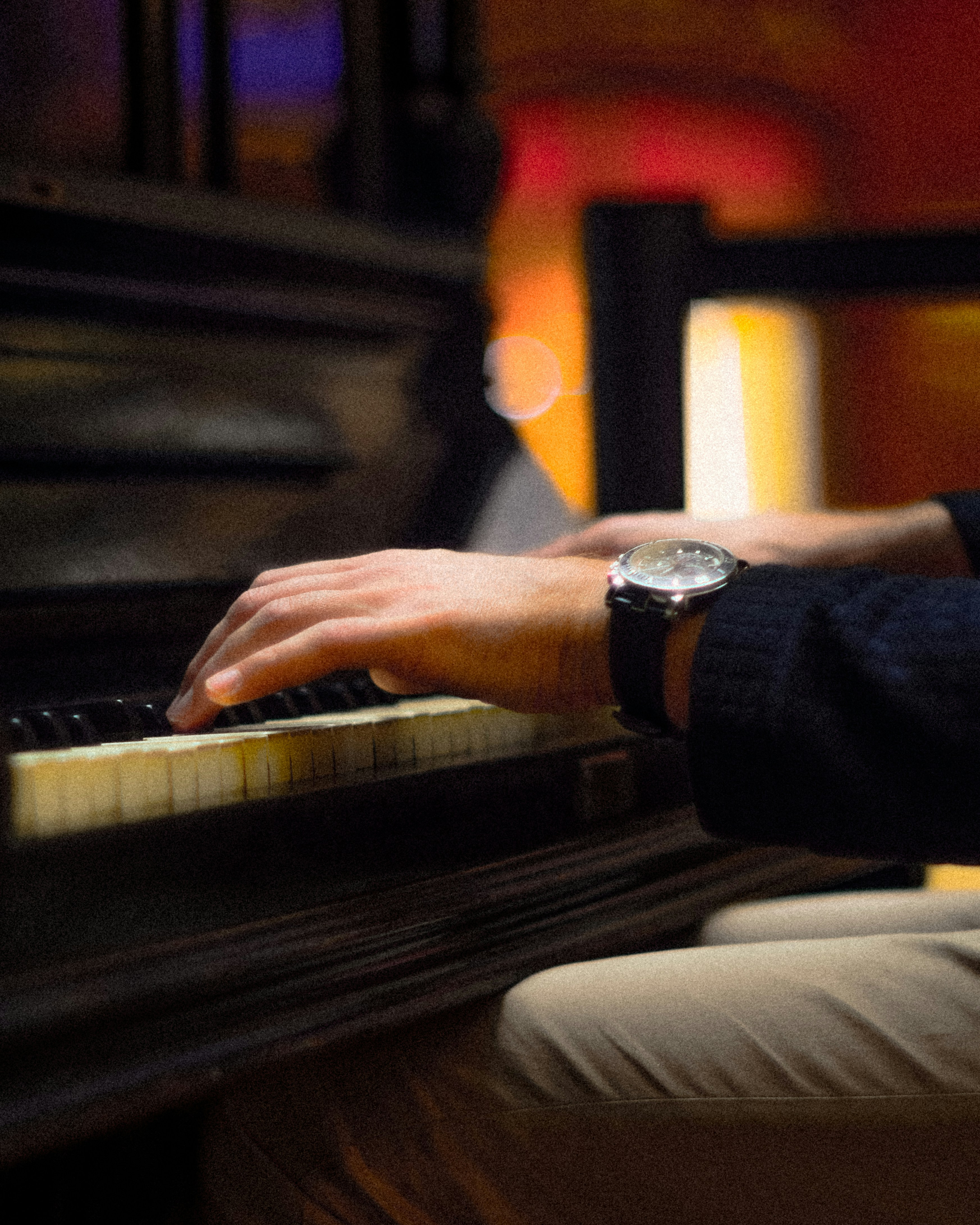 A man sitting at a piano playing a musical instrument