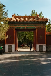 A person standing in front of a red building