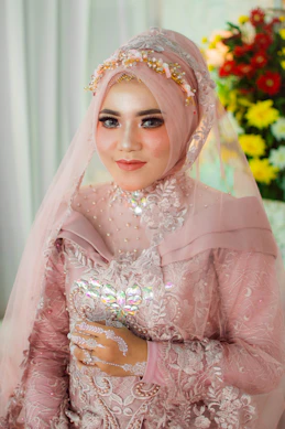 A woman in a pink hijab and veil