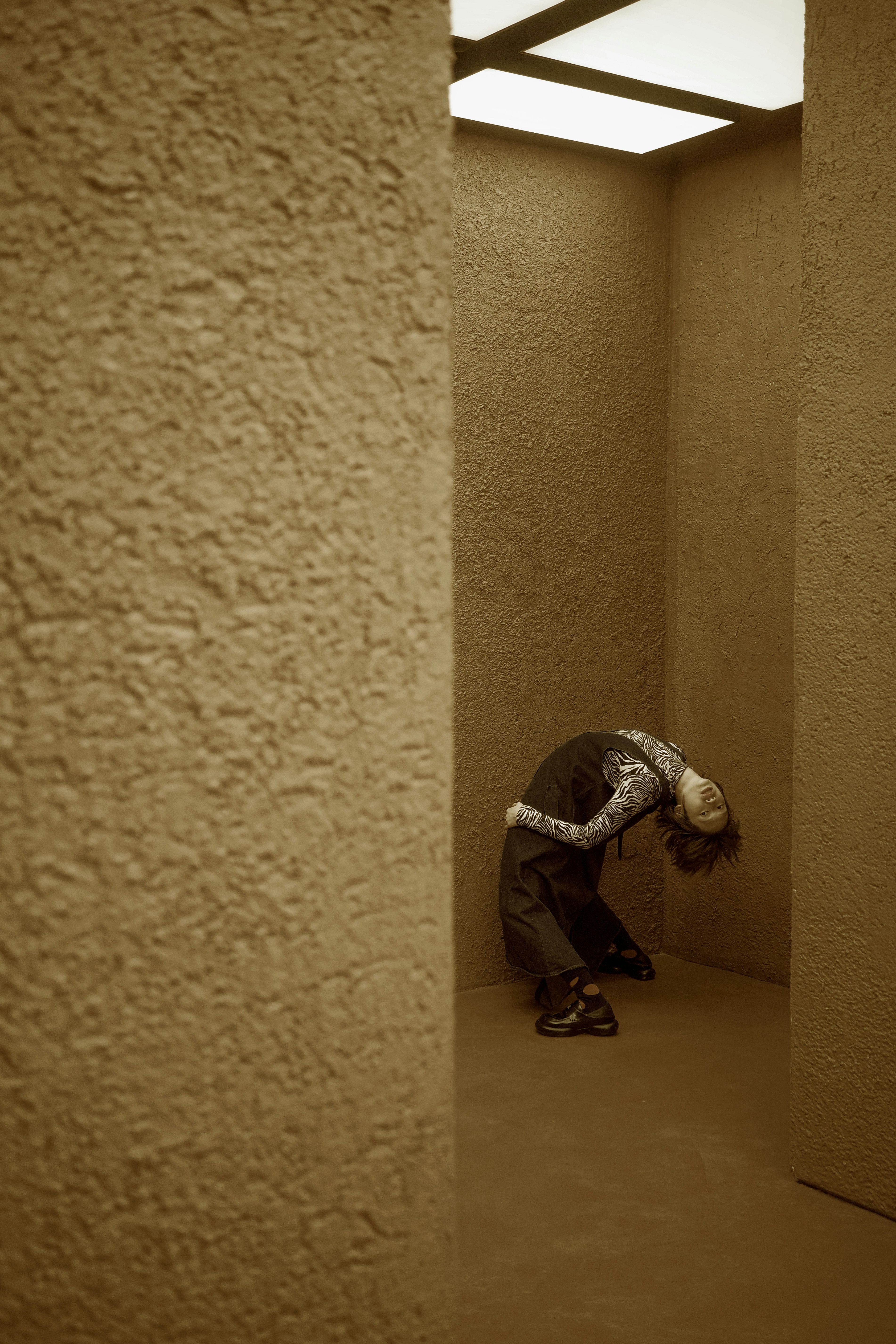 A person kneeling down in an empty room
