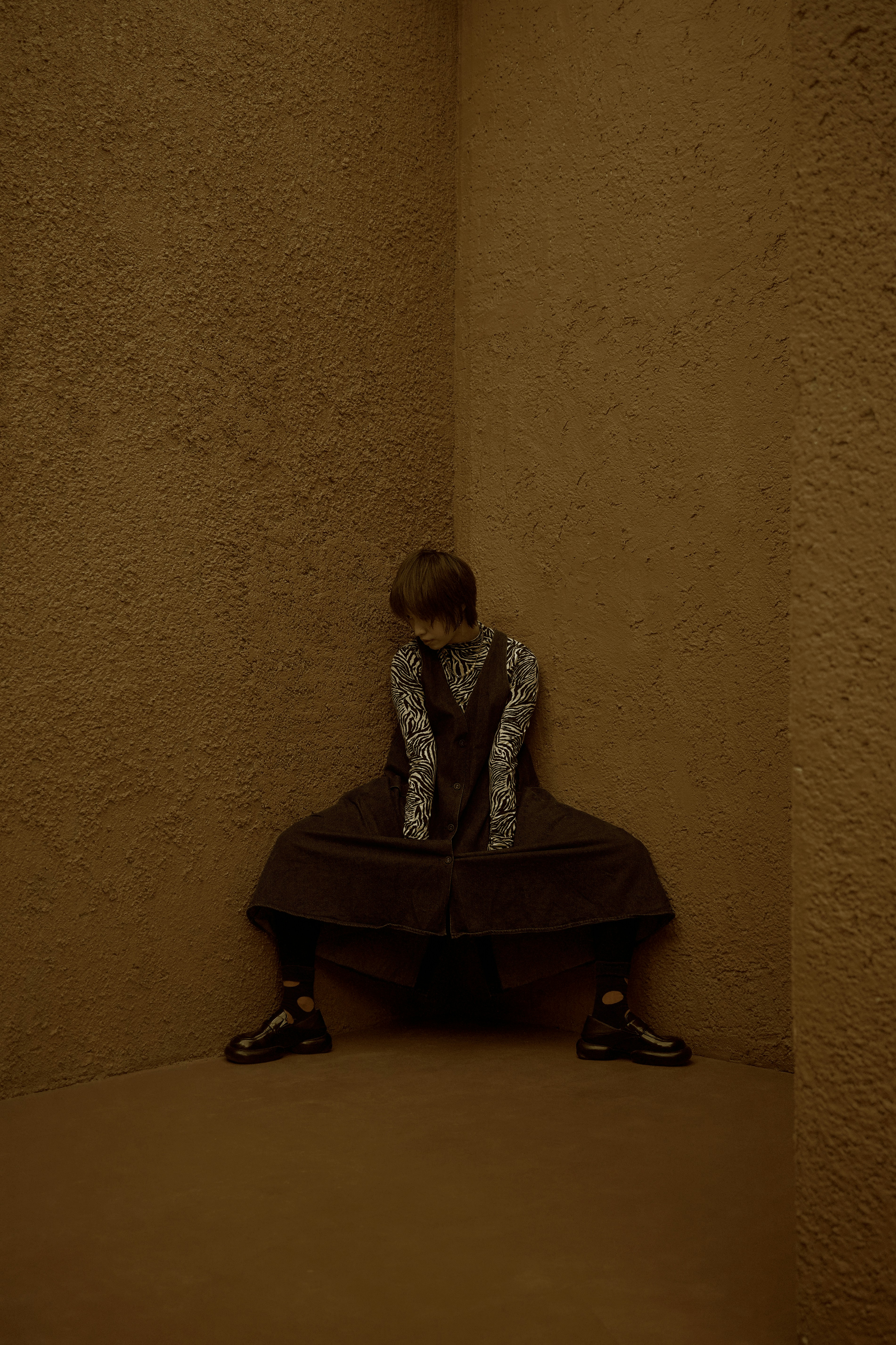 A person sitting on a bench in a room photo Free Experimental Image