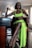A woman in a neon green dress sitting at a table