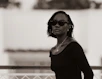 A woman wearing sunglasses and a black top