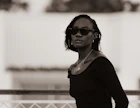 A woman wearing sunglasses and a black top