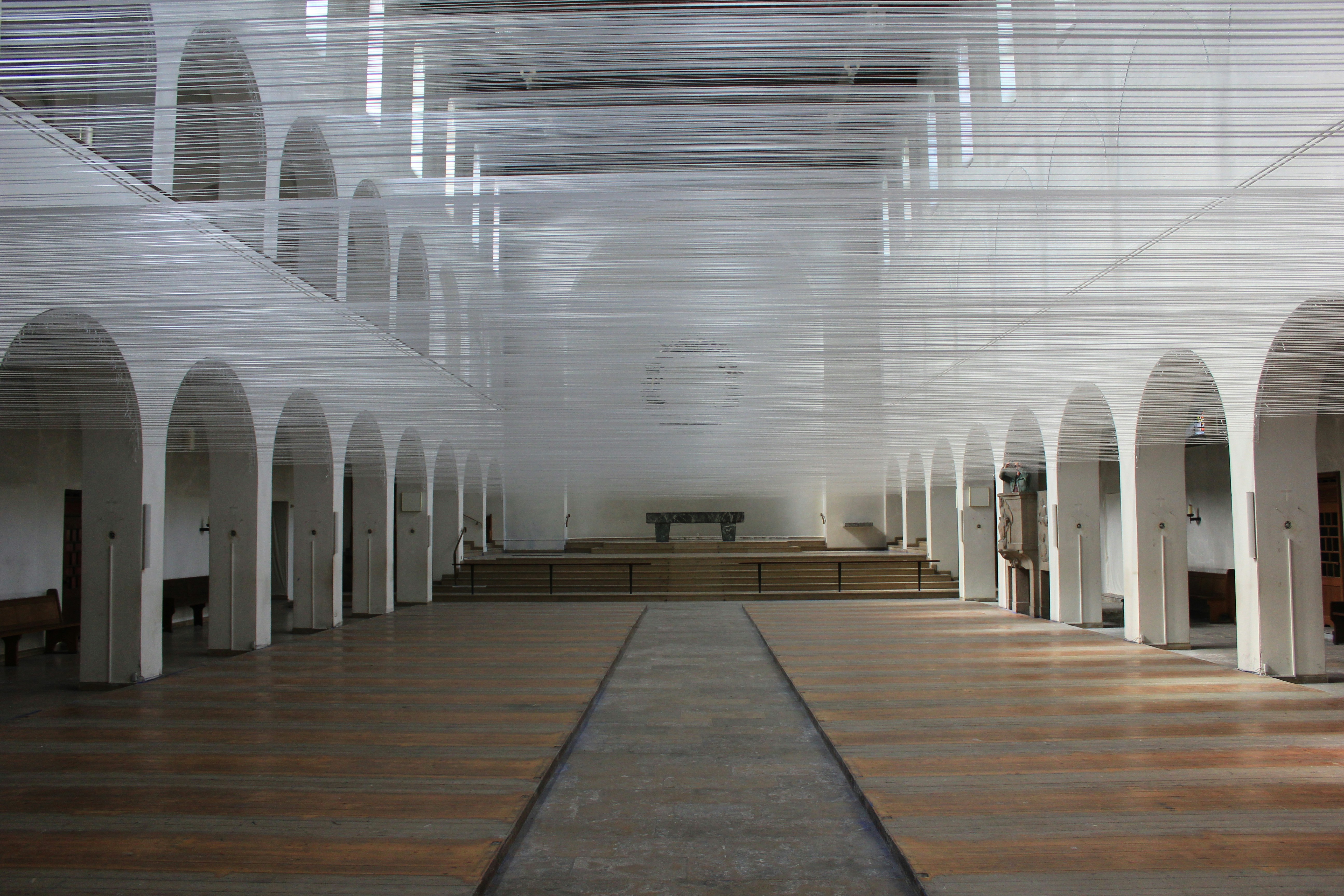 A church with a row of pews and a row of benches