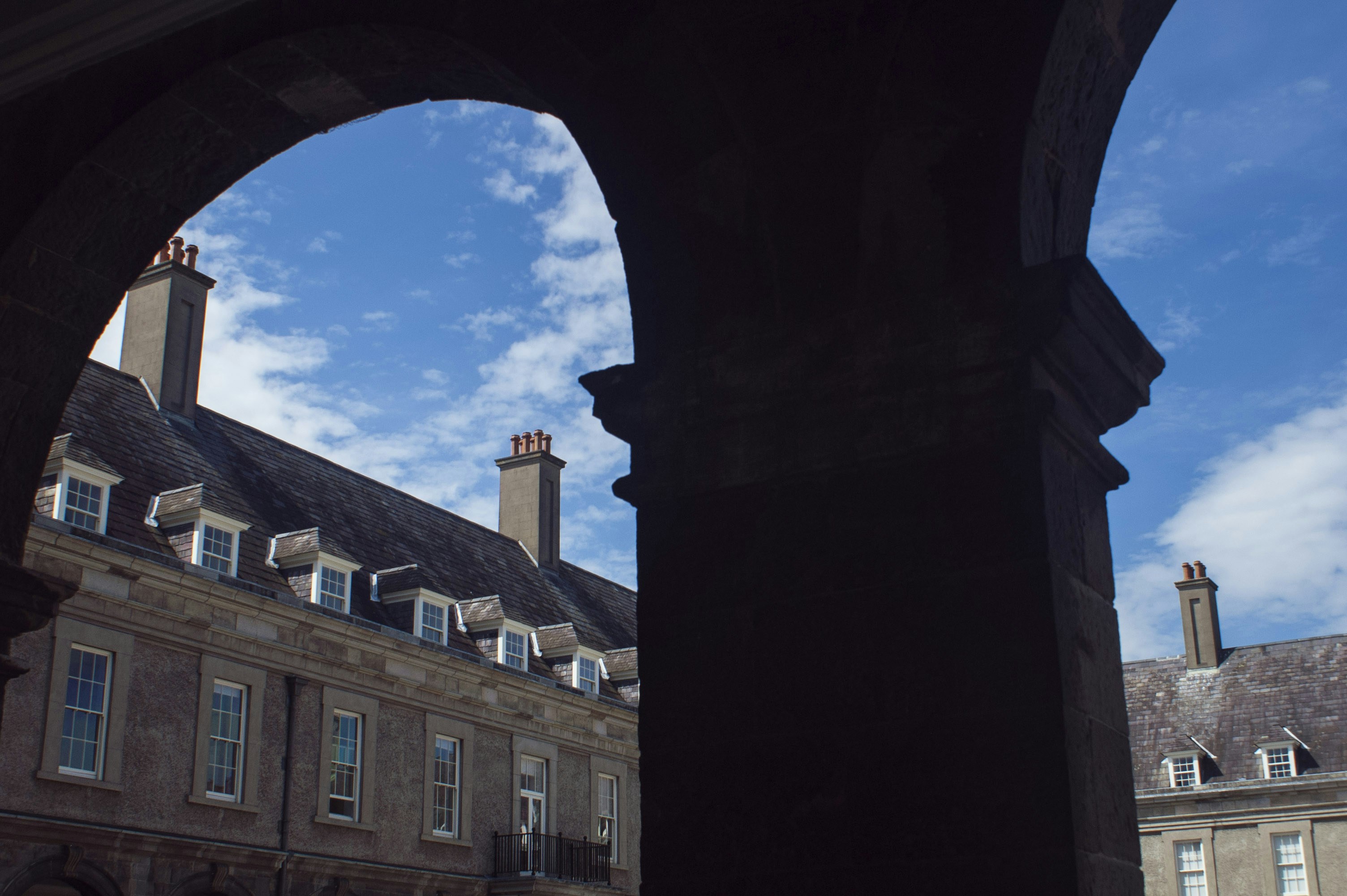 A view of a building through an arch, 