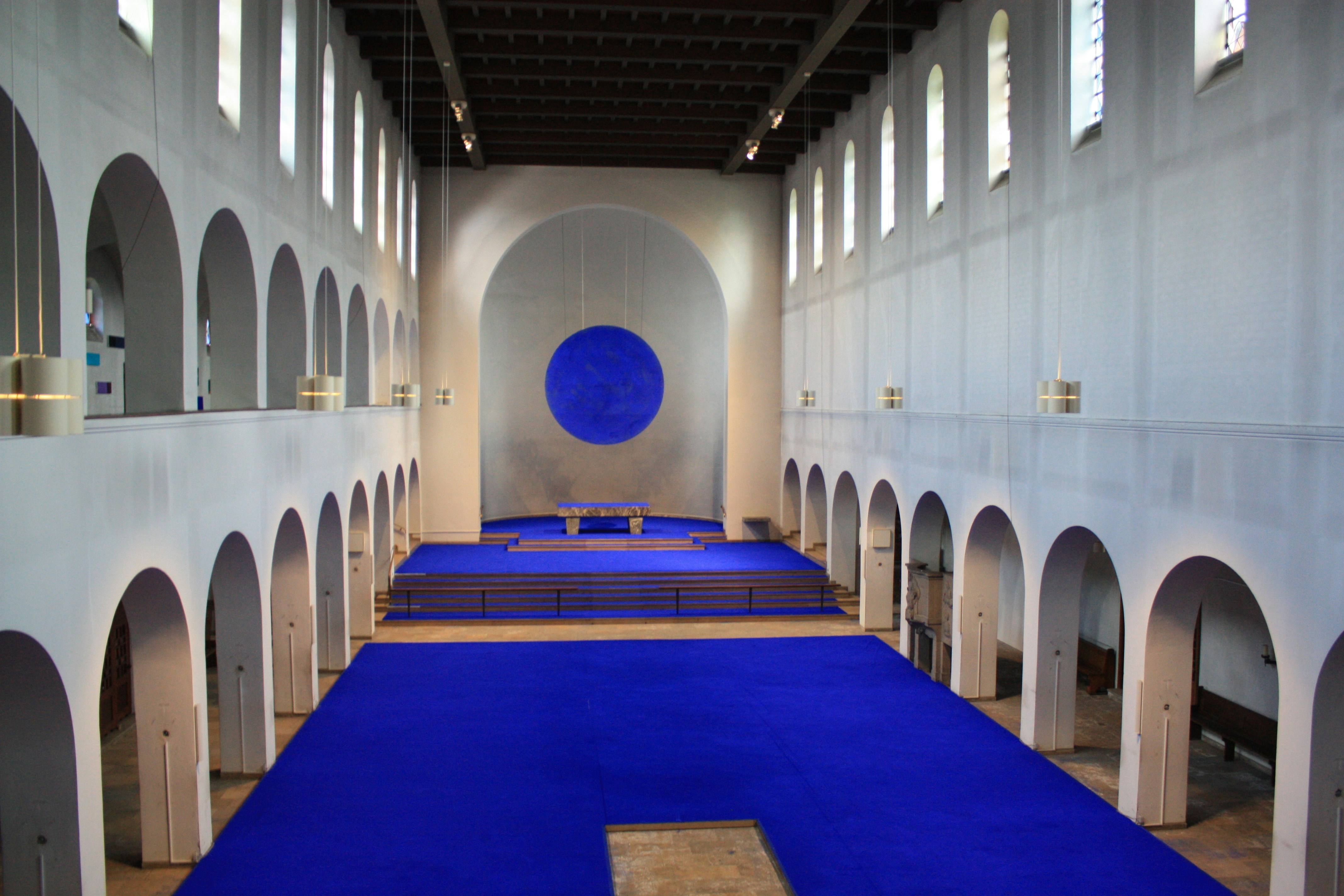 A large room with a blue carpet and white walls