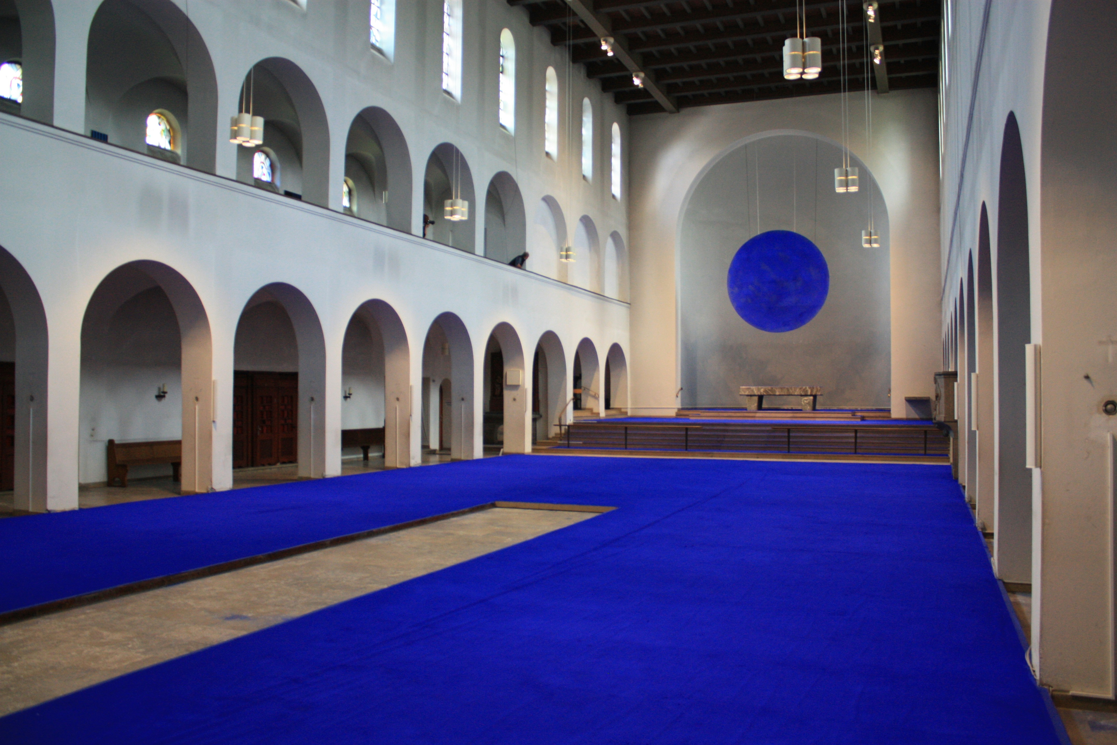 A large room with a blue carpet and white walls