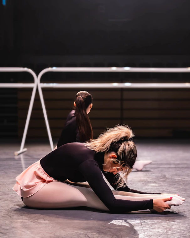 A couple of women sitting on top of a floor