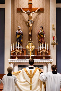 A group of people standing in front of a cross