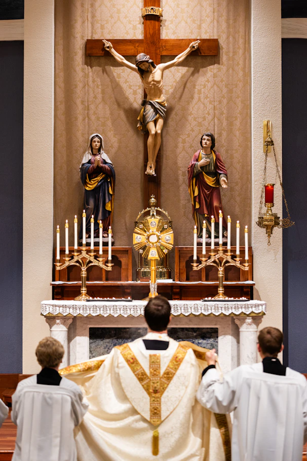 A group of people standing in front of a cross