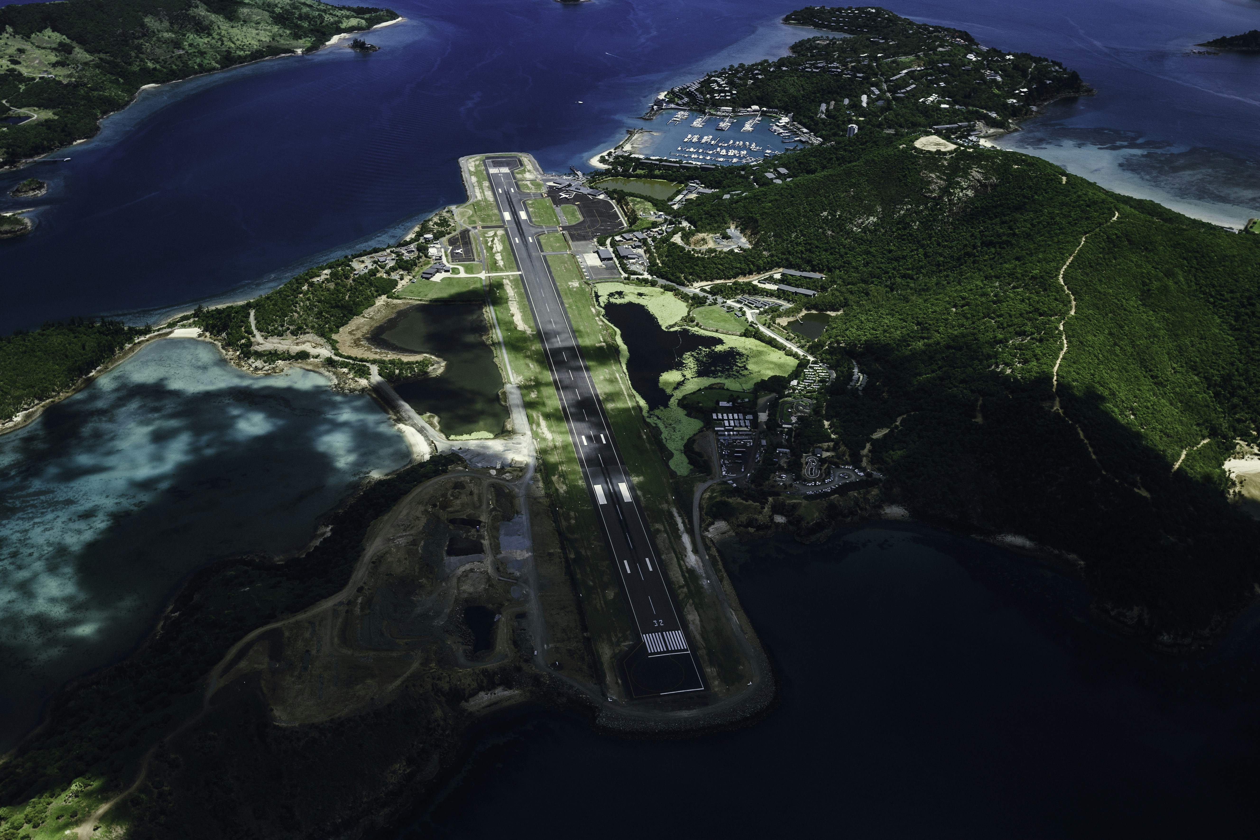 An aerial view of an airport in the middle of the ocean, 