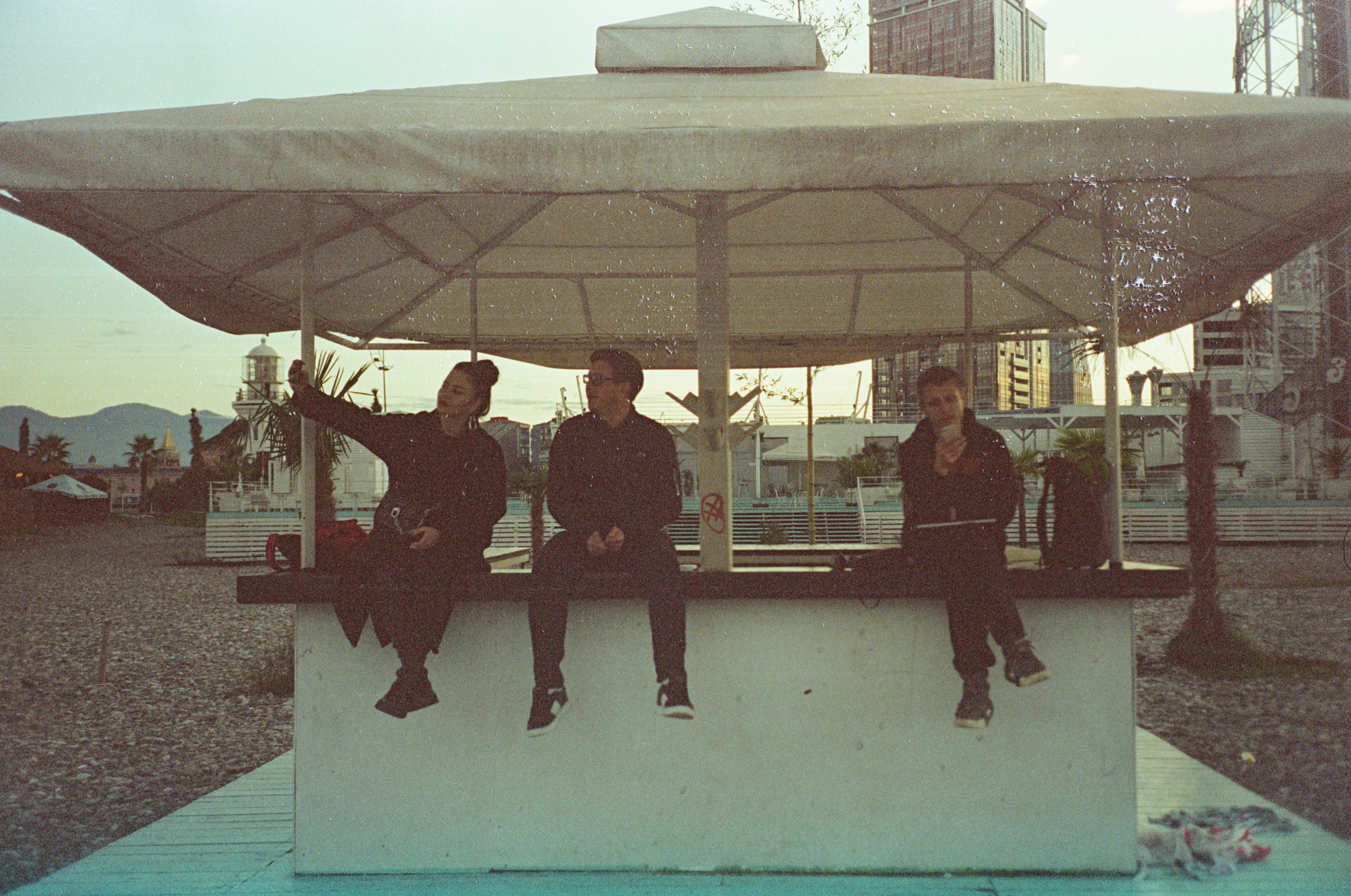A group of people sitting on top of a white structure