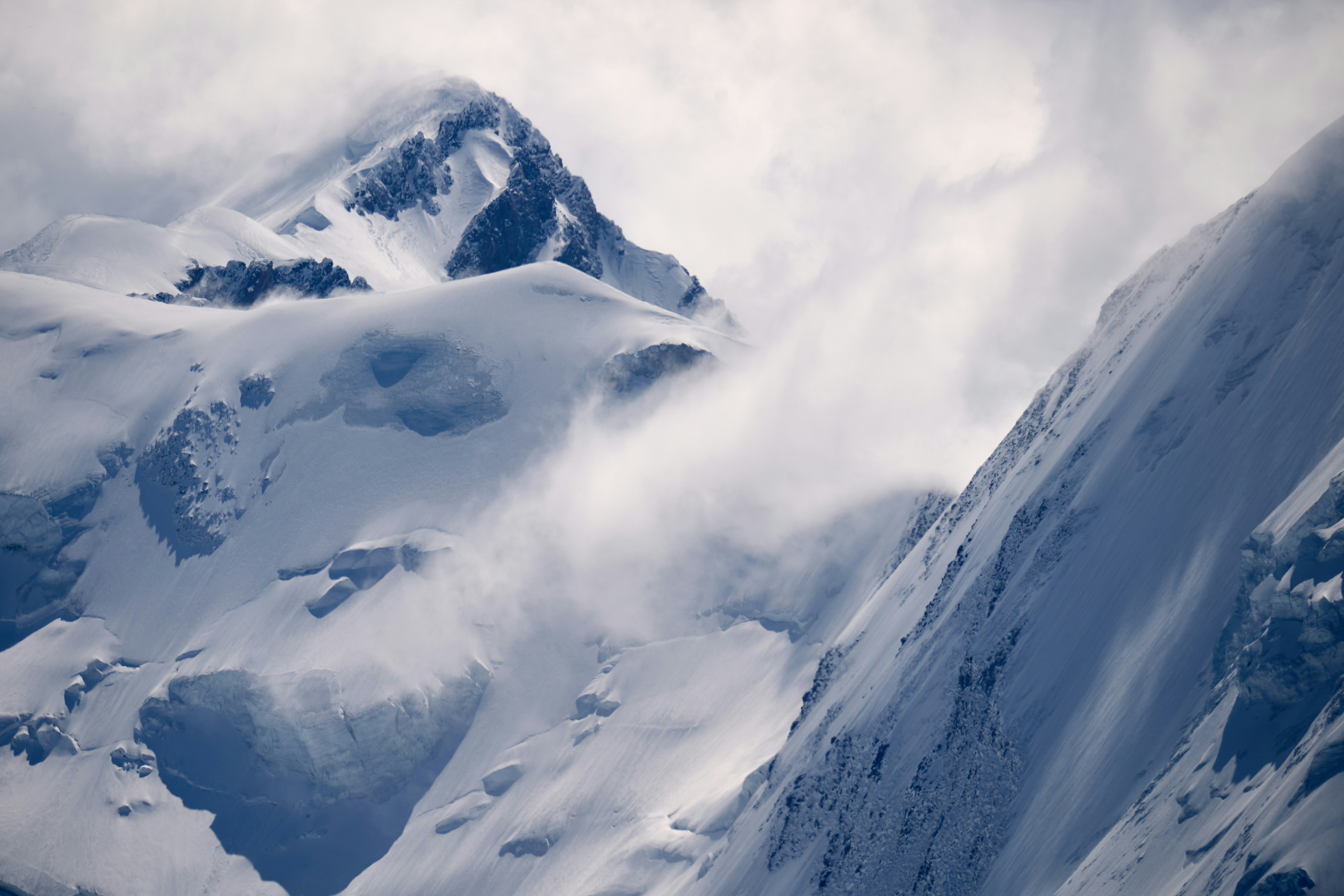 A person skiing down a snow covered mountain