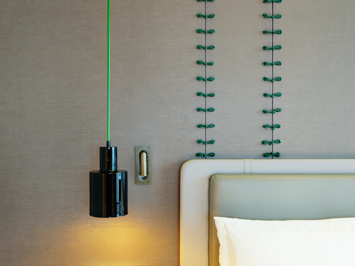 Navy blue bedding with green wall art