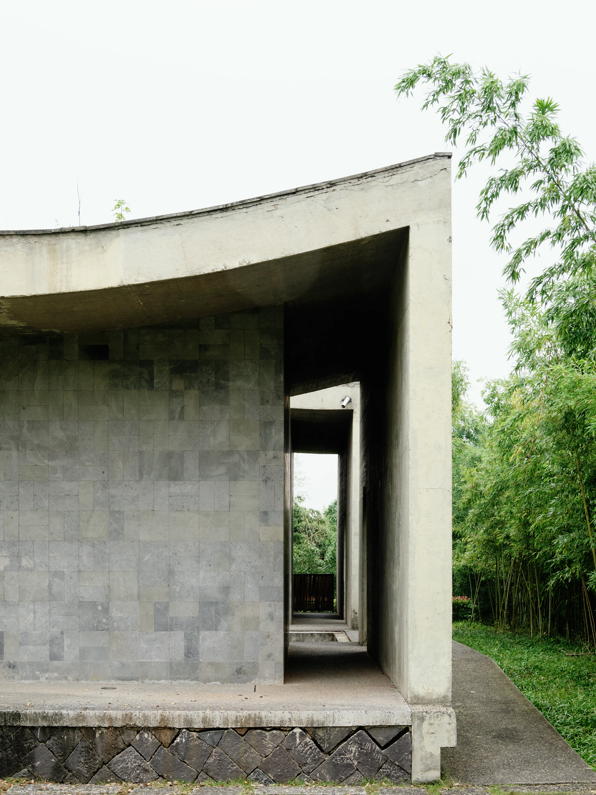 Betonhaus zwischen Bäumen am Waldrand