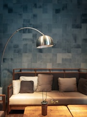 A living room with a couch a table and a lamp