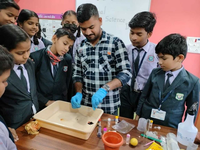 Teacher helping a student with a science experiment in a school laboratory