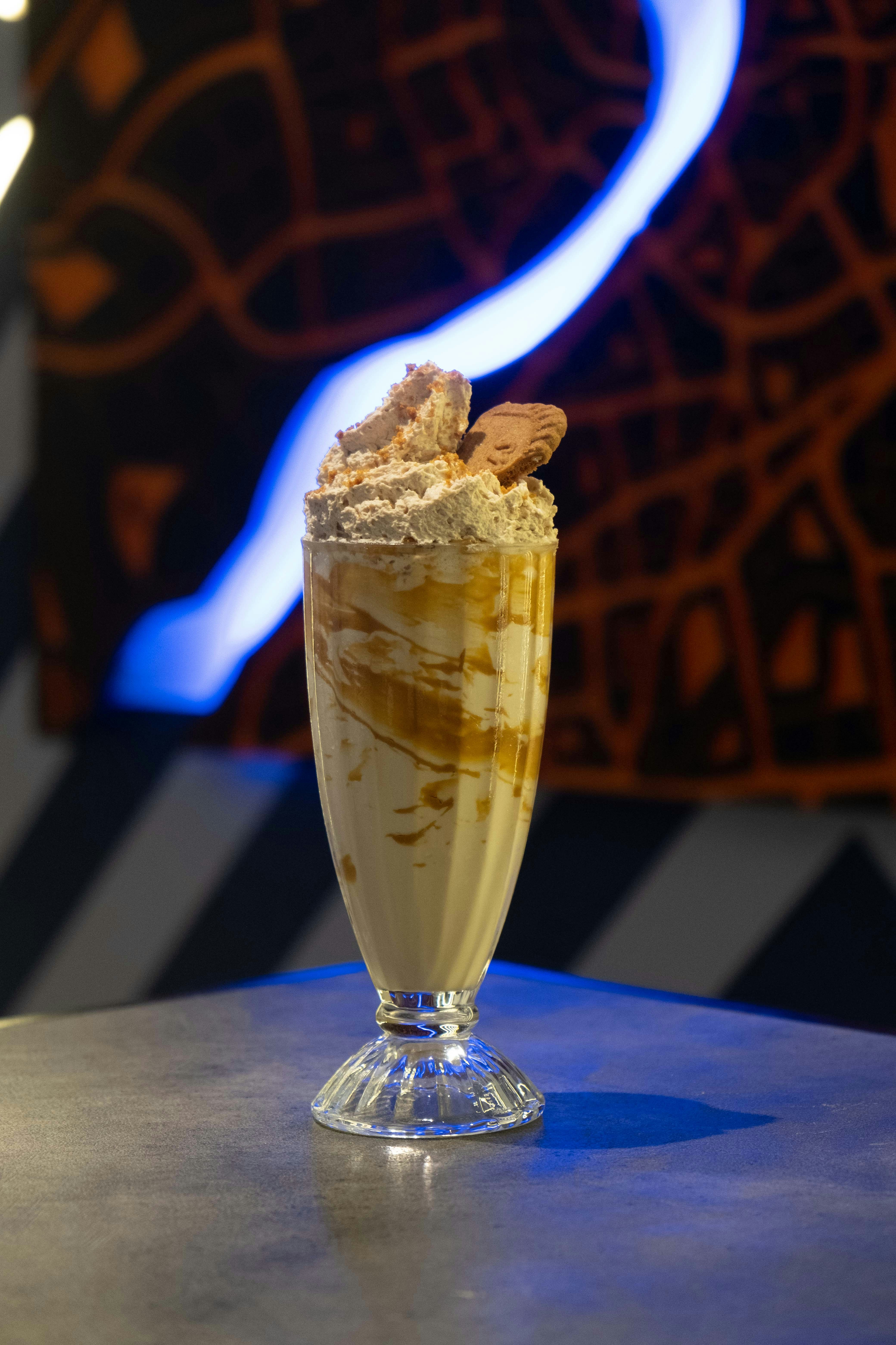 A glass of ice cream with cookies on top