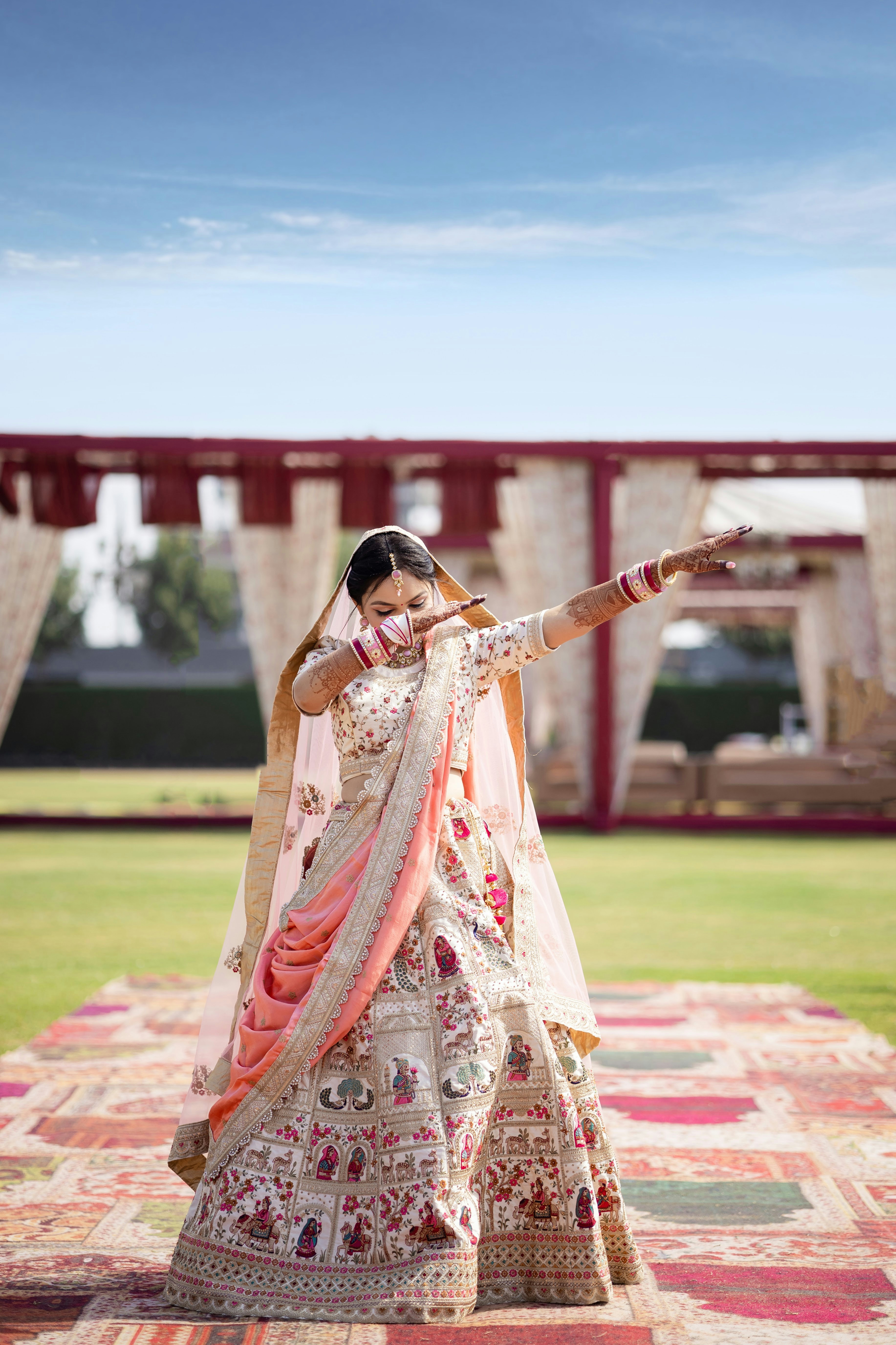 A woman in a white and orange indian dress