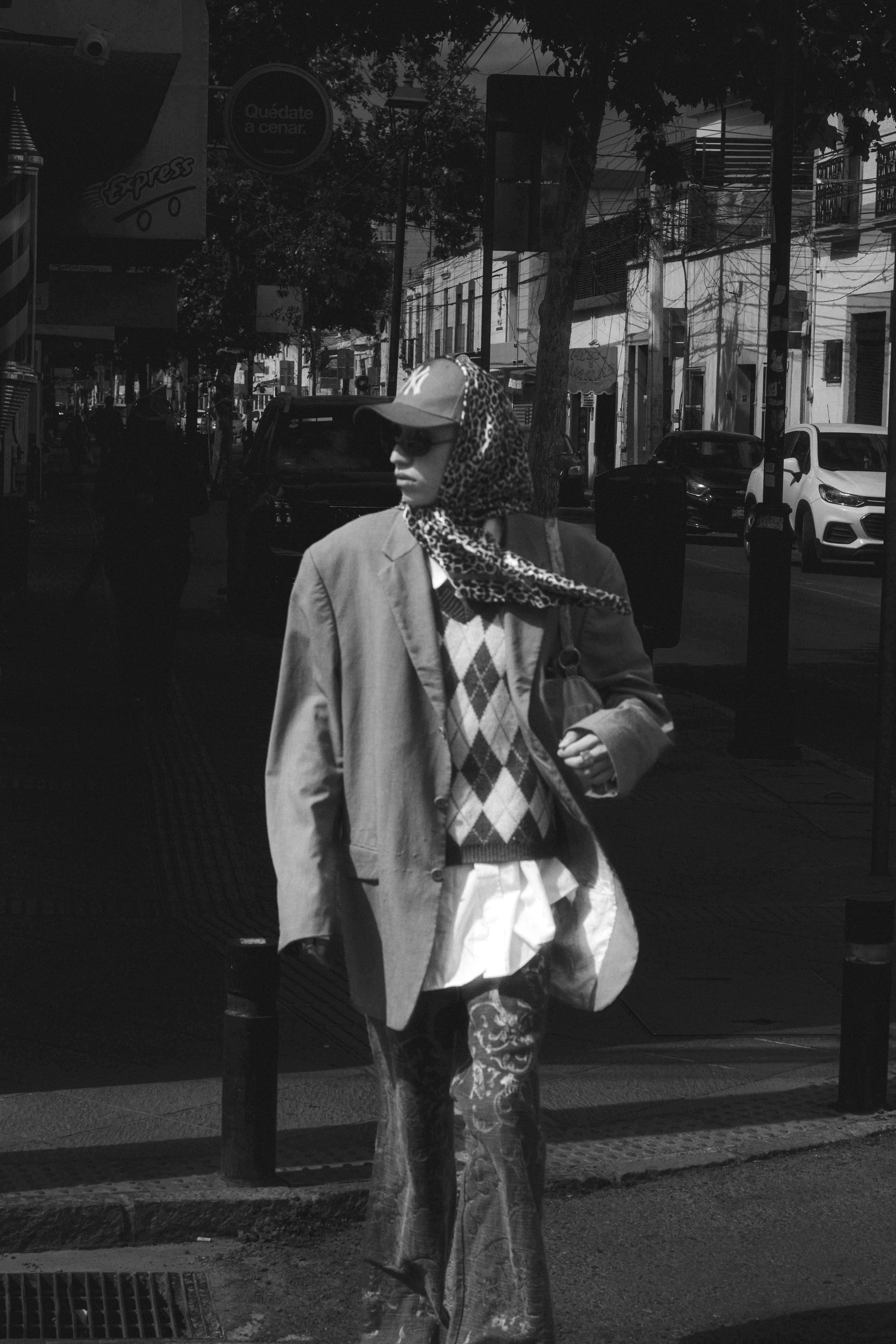 A man in a suit and tie walking down the street