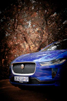 A blue car parked on the side of a road