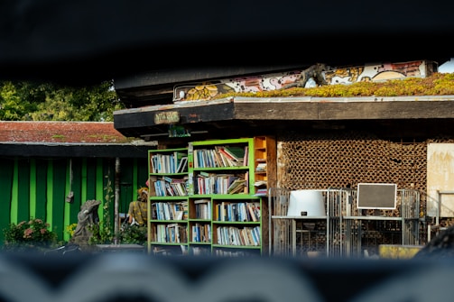 A building with a green roof and a book shelf