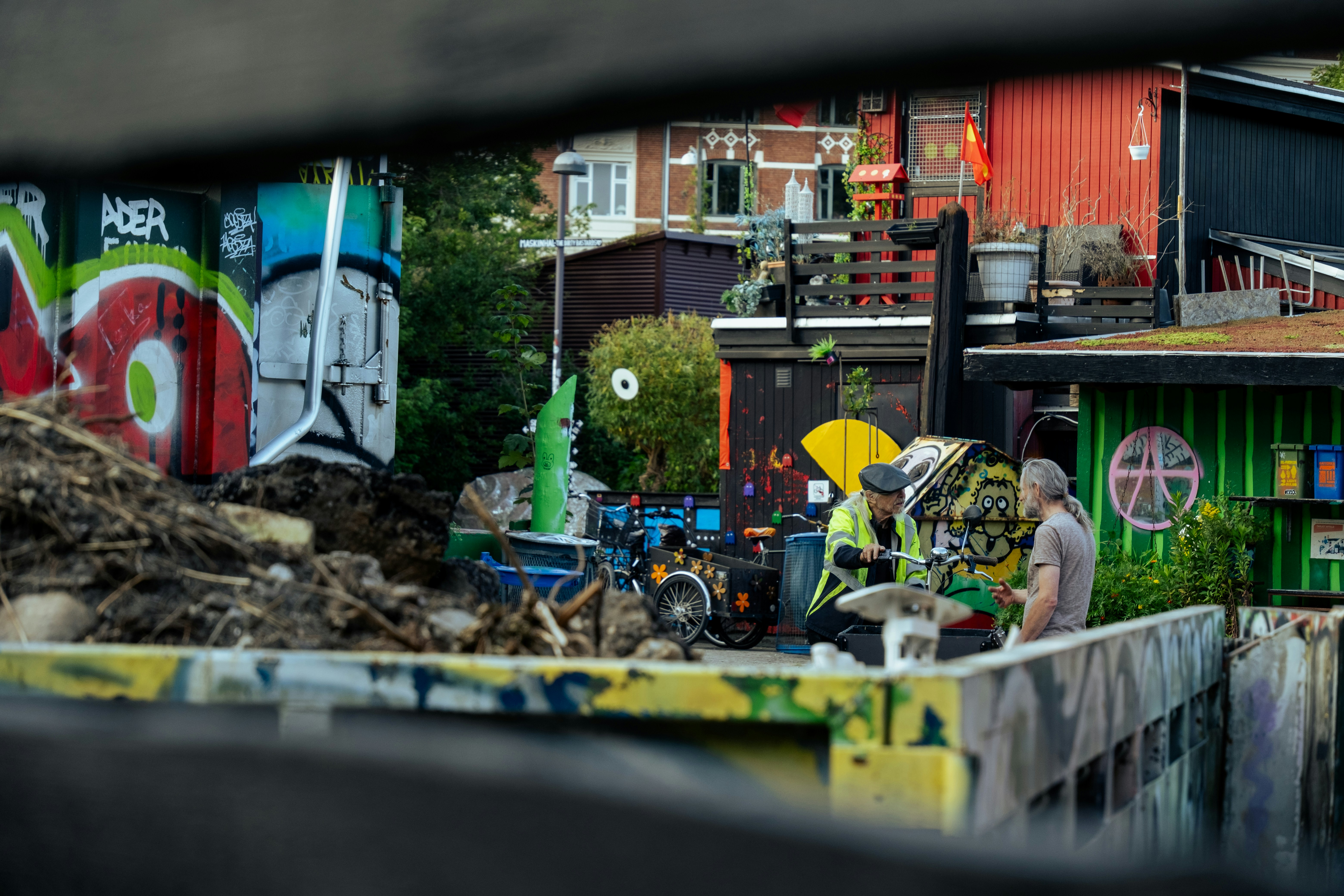 A group of people standing around a pile of garbage