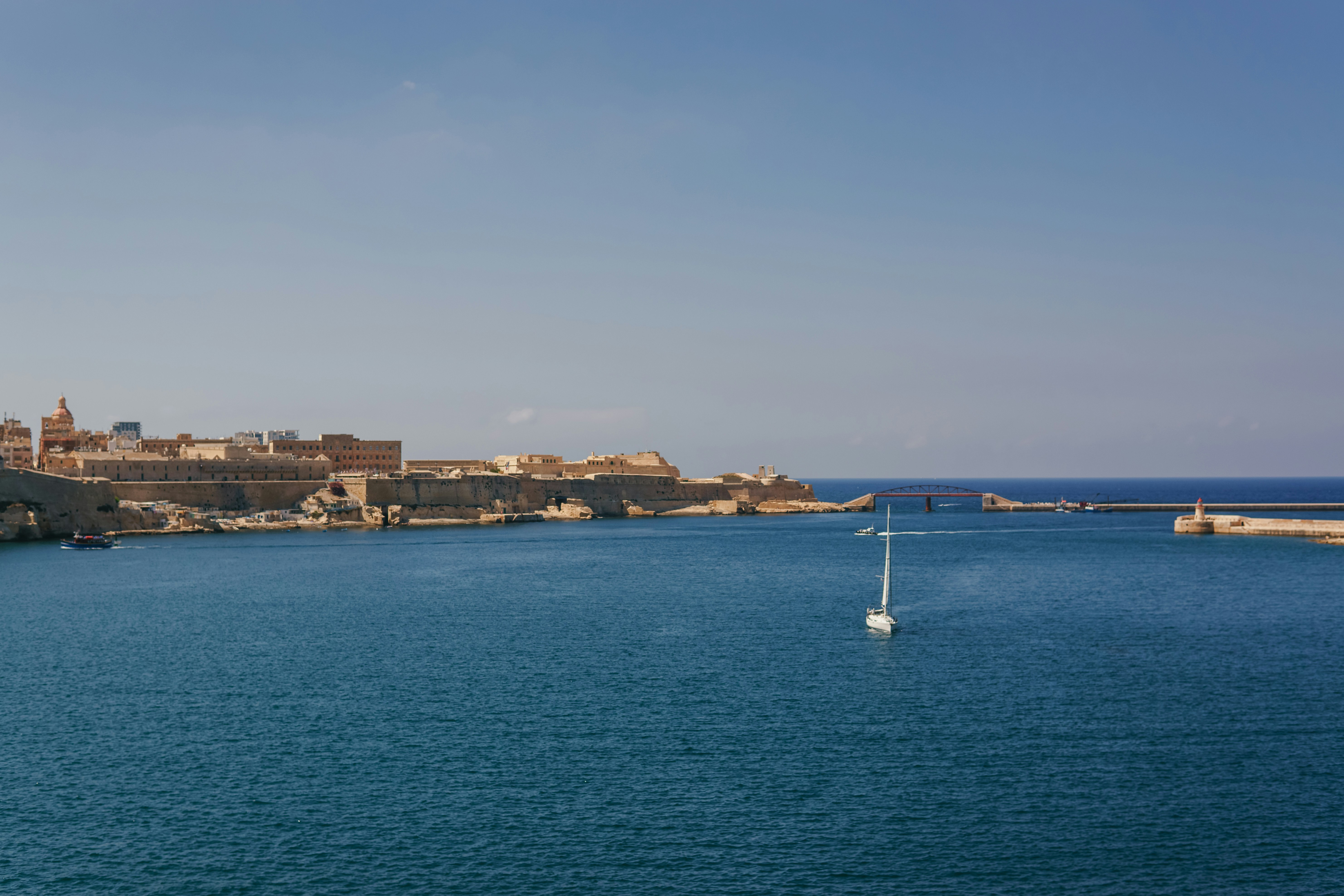 A body of water with a city in the background
