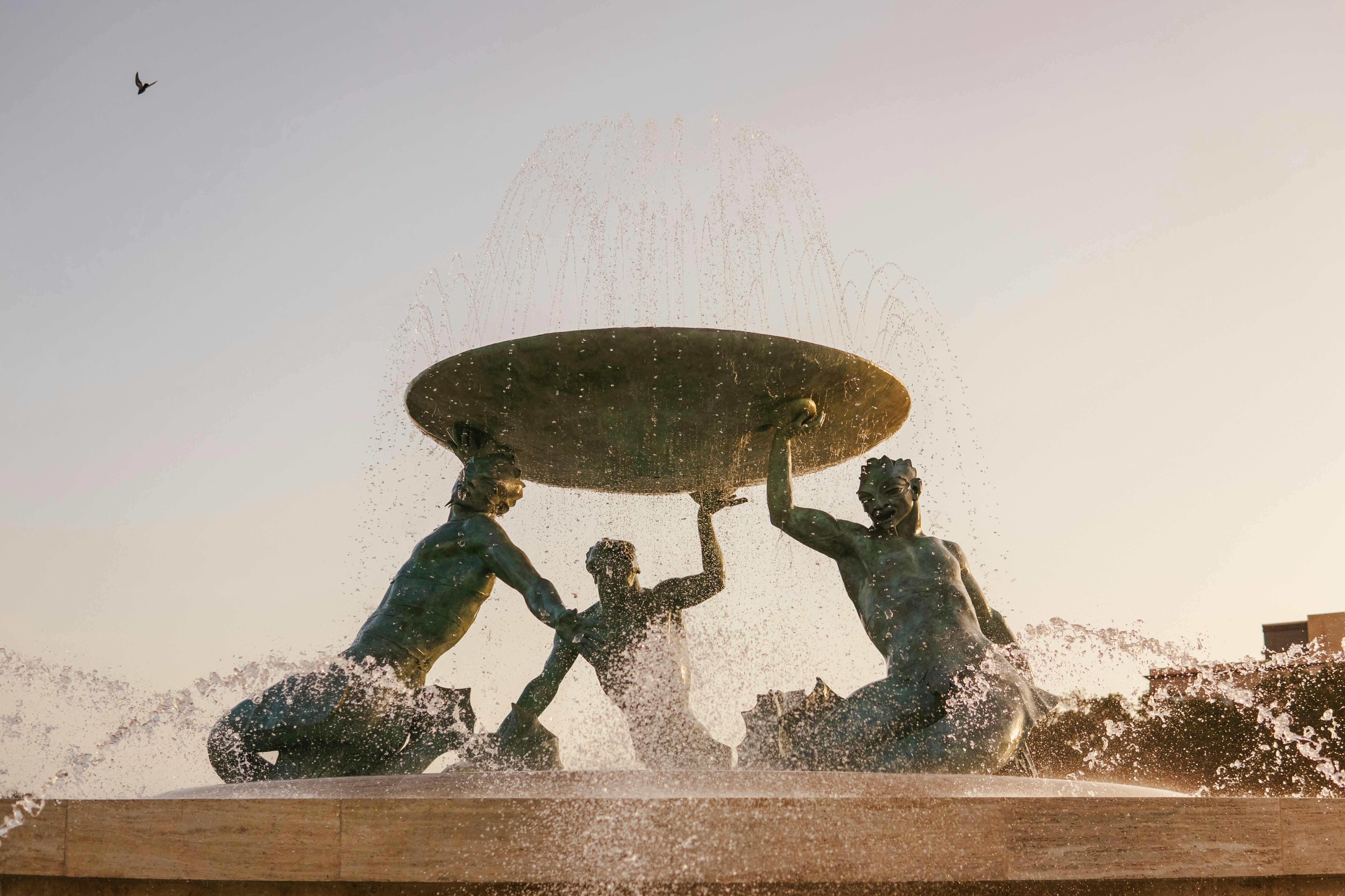 A group of people sitting on top of a fountain