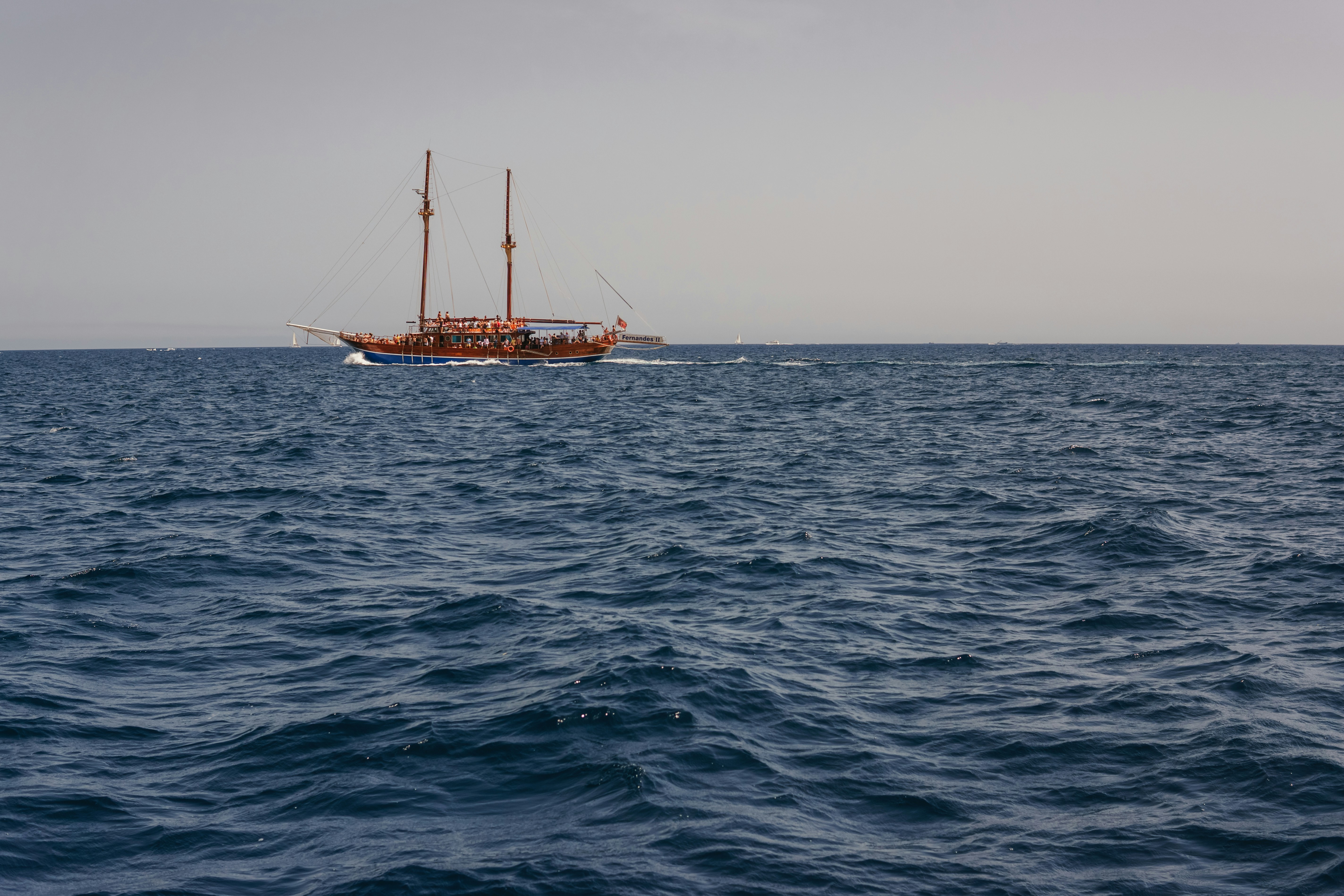 A boat floating on top of a large body of water