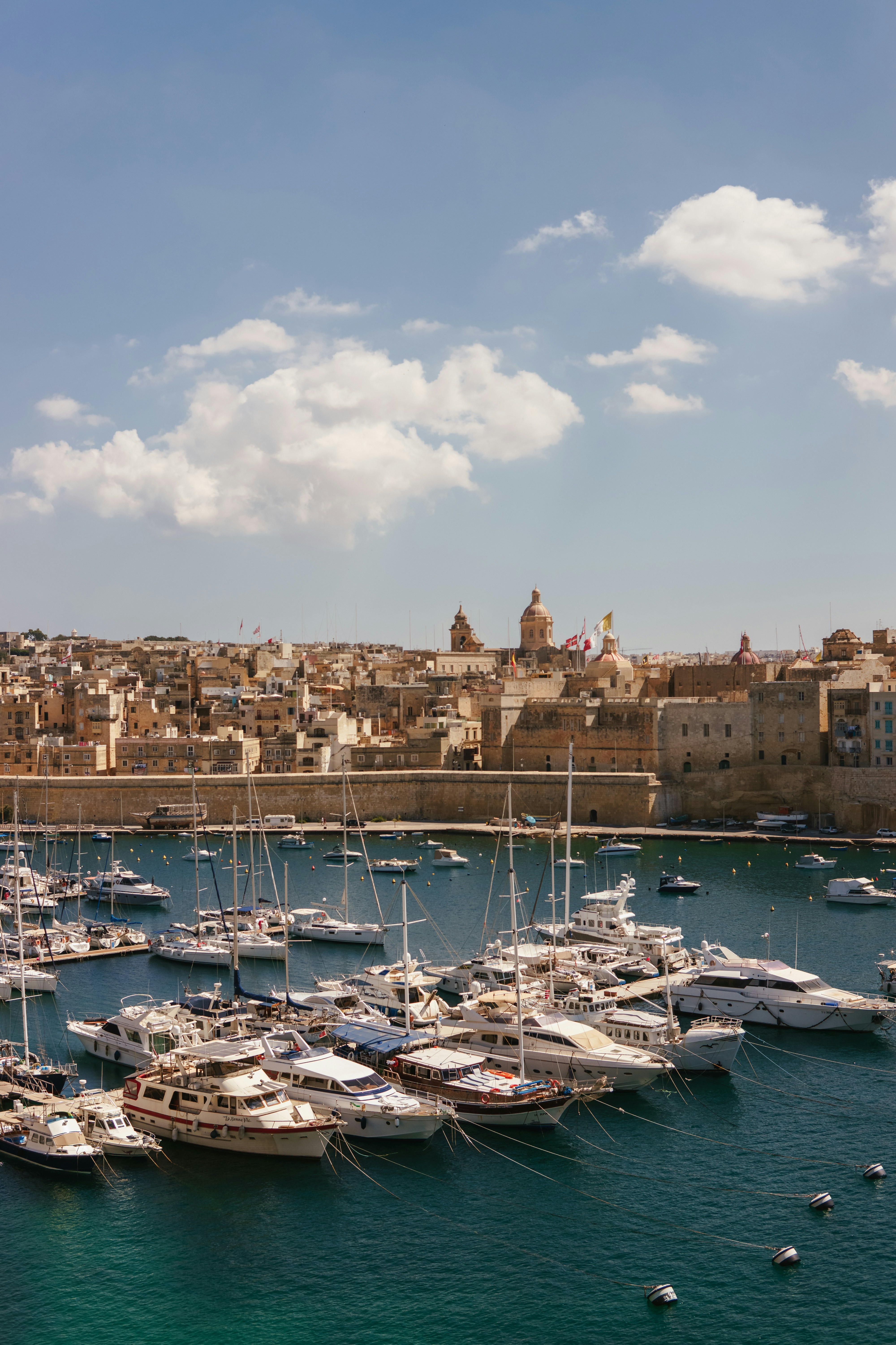 A harbor filled with lots of boats next to a city