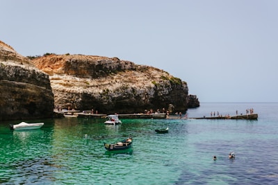 A group of boats floating on top of a body of water