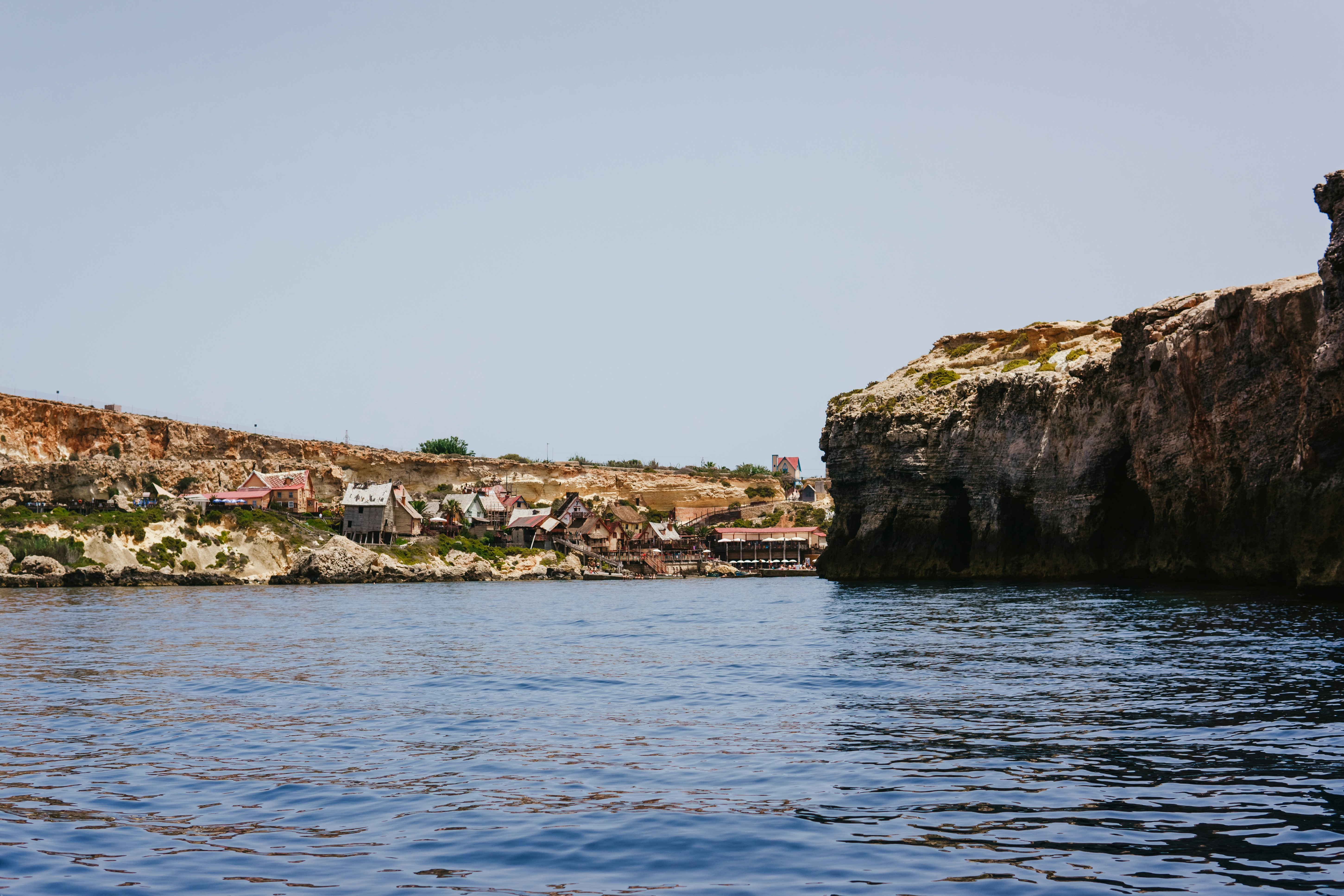 A body of water with a rock outcropping in the middle